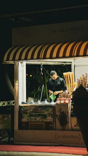 Vendor at small La Gelateria kiosk serving cones at night in Naples