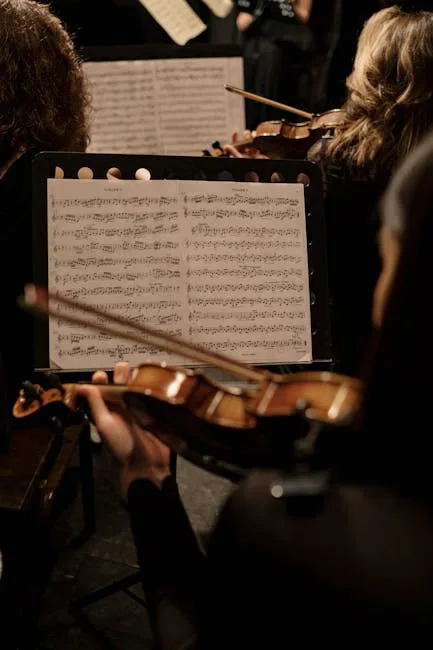 Violinists reading sheet music during an orchestra performance in Naples