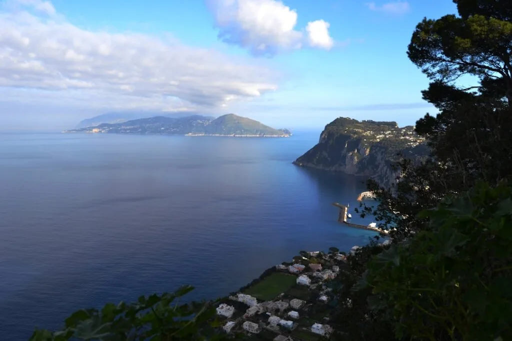 Coastline near Naples with steep cliffs and distant island silhouettes.