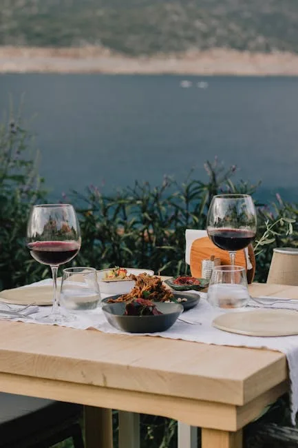Romantic table with red wine and dishes overlooking the Bay of Naples