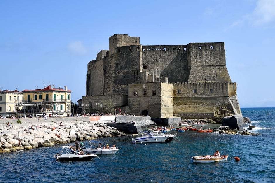 Castel dell'Ovo on Naples waterfront with small boats in foreground