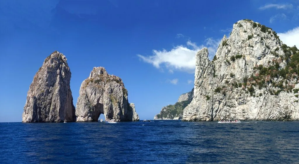 Three Faraglioni sea stacks rising from blue waters off Capri