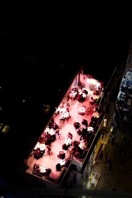 Naples rooftop terrace lit pink with diners at round tables