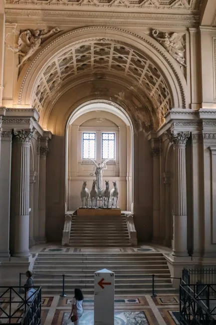 Grand marble hall with chariot statue and steps in Naples museum