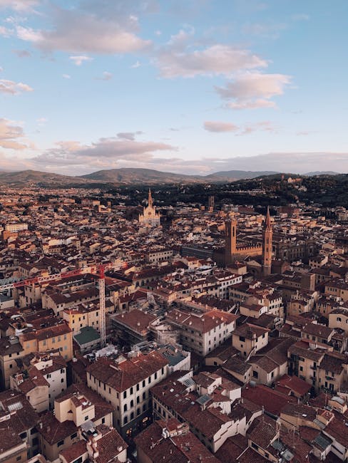 Aerial view of terracotta rooftops and church towers at sunset