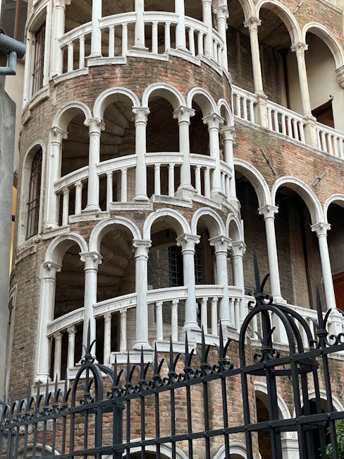 Ornate external spiral marble staircase on a historic Neapolitan palazzo façade
