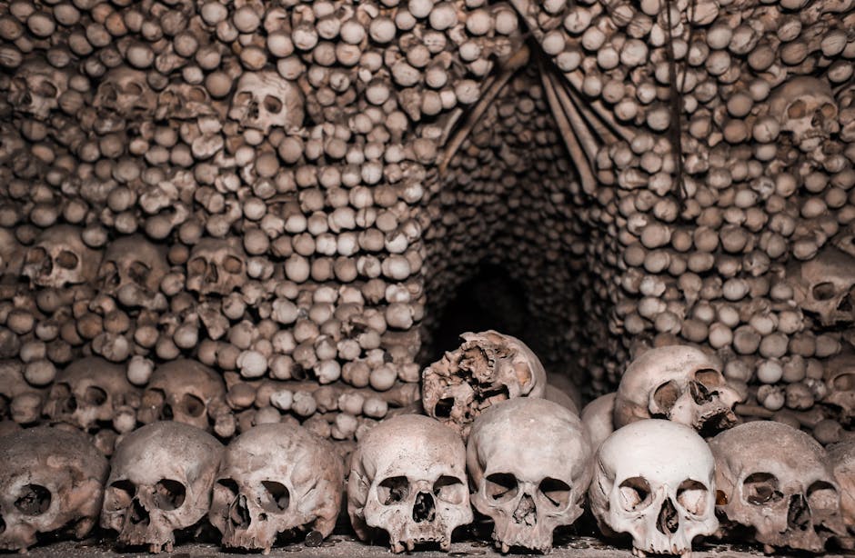 Stacked skulls and bones forming an ossuary tunnel at Fontanelle, Naples