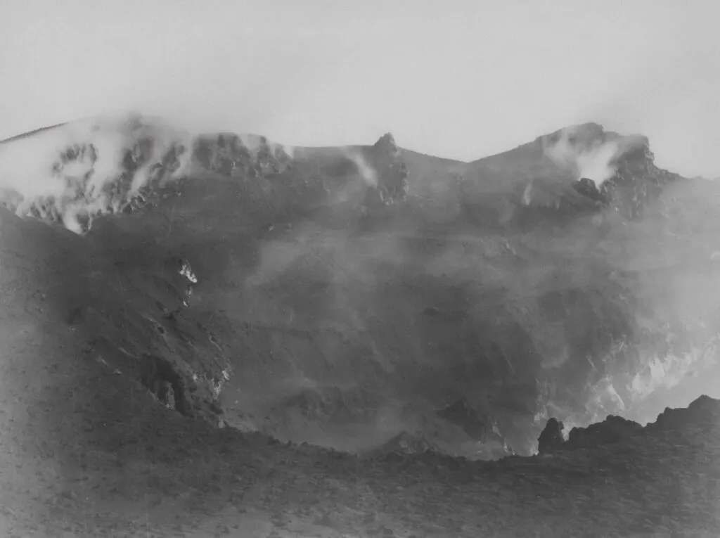 Steamy inner crater and rocky rim of Mount Vesuvius near Naples