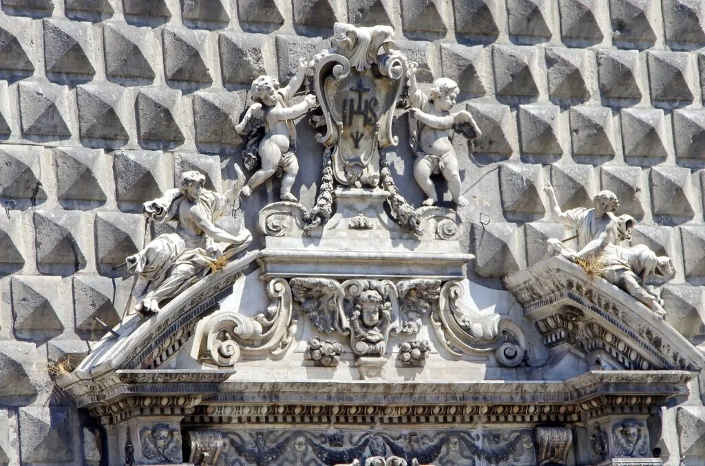 Baroque entrance with cherub sculptures on Naples' Gesù Nuovo facade