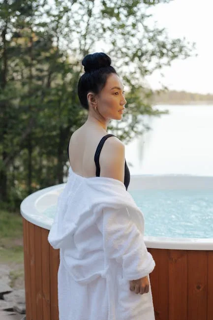 Person im Bademantel neben einem Außenwhirlpool mit Blick auf den Comer See