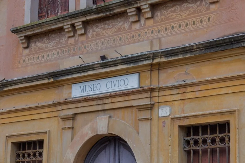Entrée du Museo Civico aux façades ocres dans les rues de San Gimignano