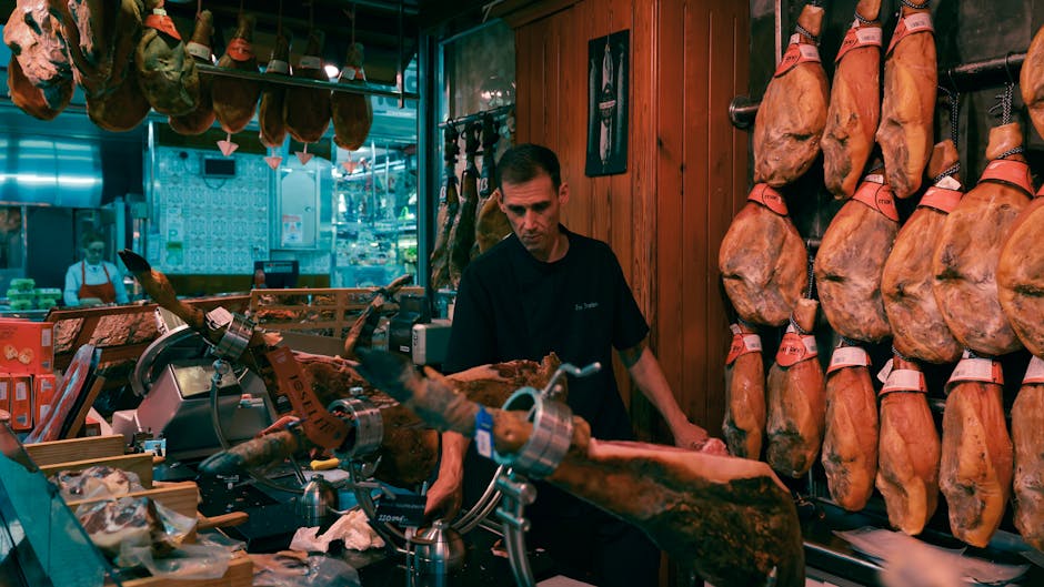 Artisan slicing cured meats at a local market stall in Tuscany
