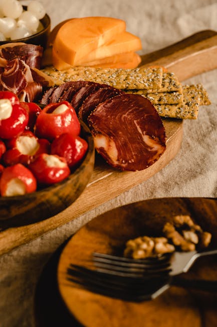 Charcuterie board with cured meats, stuffed peppers, and crackers in San Gimignano