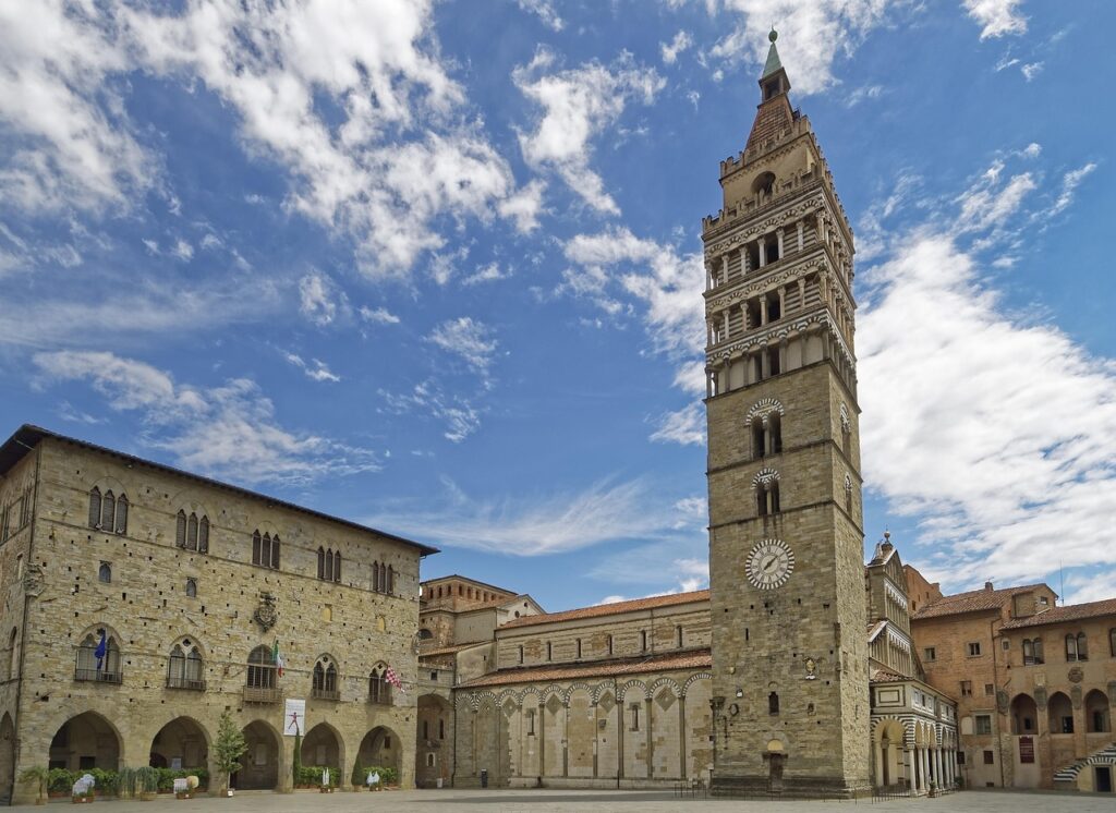 Bell tower and empty piazza in San Gimignano under blue sky