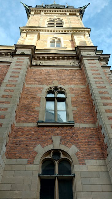 Restored historic tower façade with 19th-century decorative elements