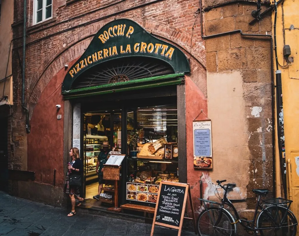 Street-level Lucca bakery window displaying breads and menu chalkboard