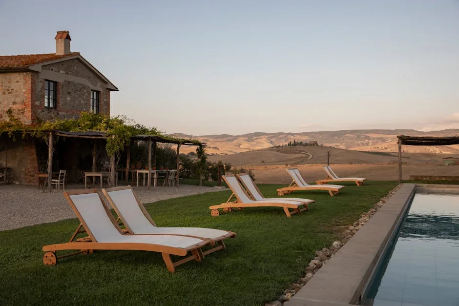 Wooden sun loungers beside a pool at a Tuscan villa near Lucca