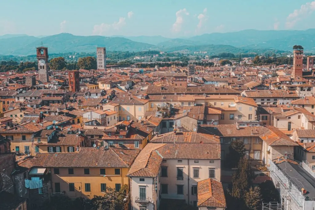 Aerial view of Lucca's terracotta rooftops and distant hills.