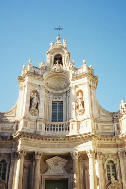 Baroque church façade in Lucca with statues and classical columns