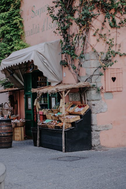 Charming street vendor stand against pink wall in Lucca's old town