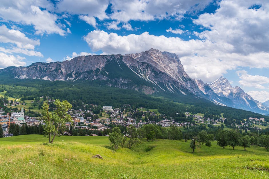Panoramic view of a Dolomites town beneath jagged mountain peaks