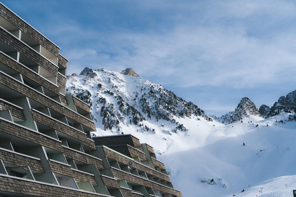 Hotelbalkone vor schneebedeckten Gipfeln der Dolomitenlandschaft