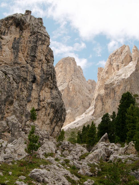 Towering pale Dolomites limestone spires above rocky scree and pines