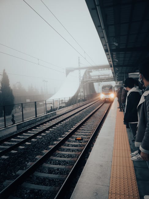 Foggy train platform with passengers awaiting arriving train to Dolomites