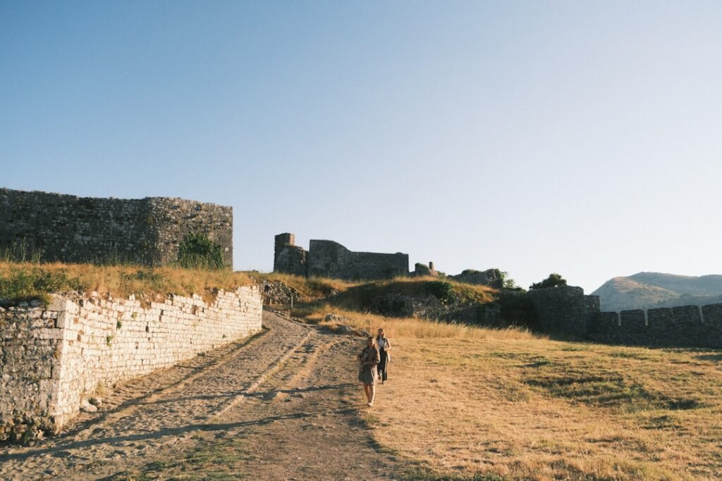 Tourist walking on ancient stone path near ruins in Tivoli