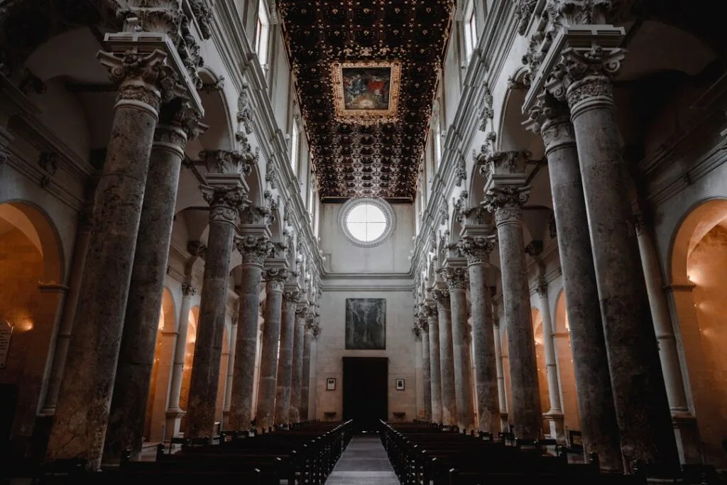 Nave with marble columns and decorated ceiling inside Lecce cathedral