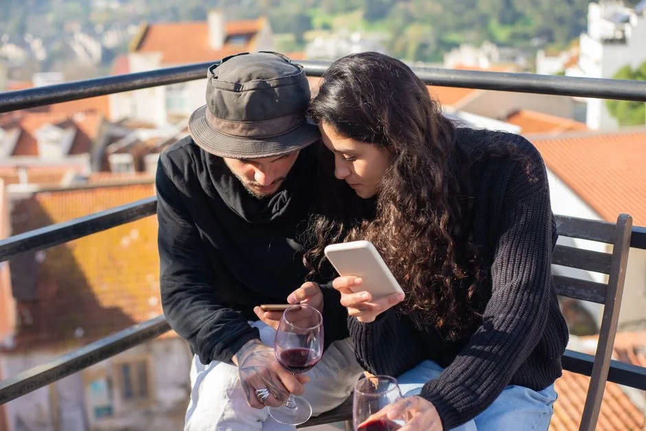 Couple checking reservation confirmation on a smartphone at a café