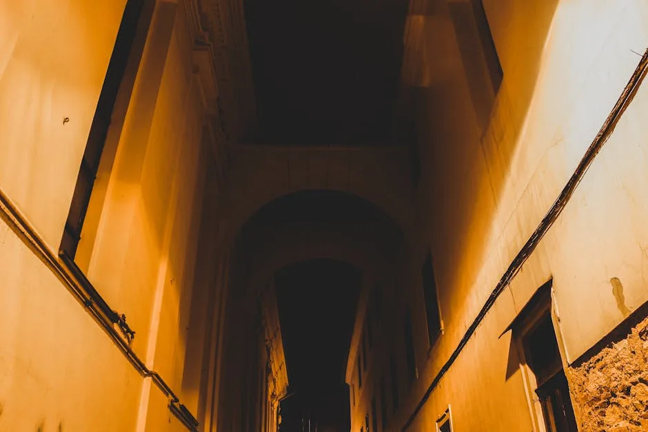 Narrow alley lit by warm lights in the historic center