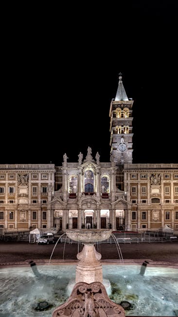 Night view of church bell towers and fountain