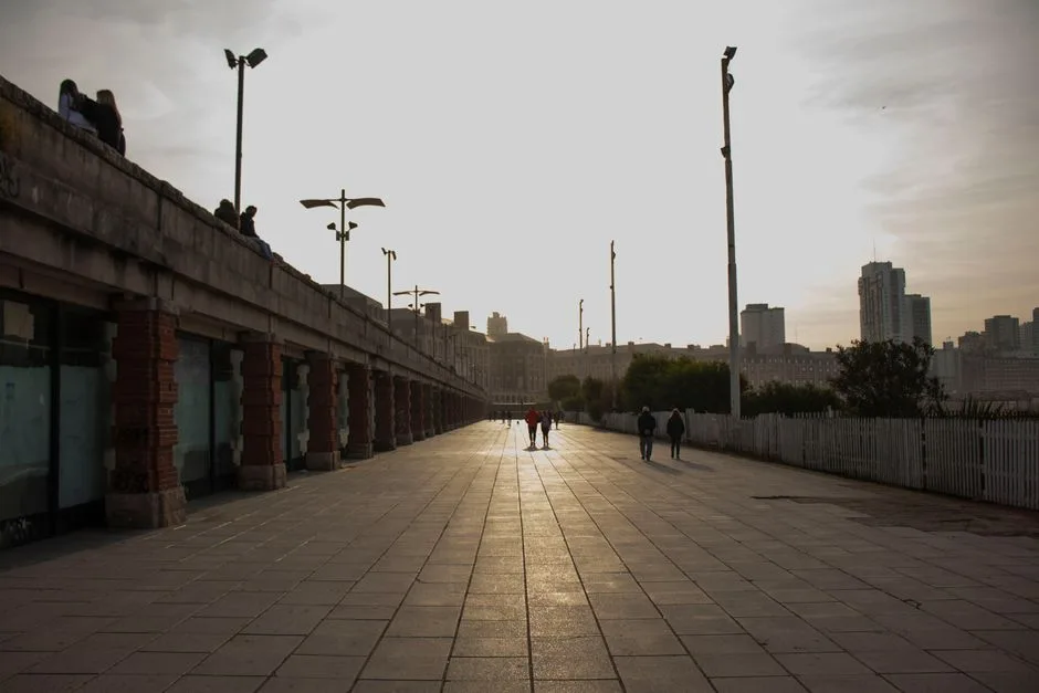 San Cataldo promenade at sunset with dog walkers