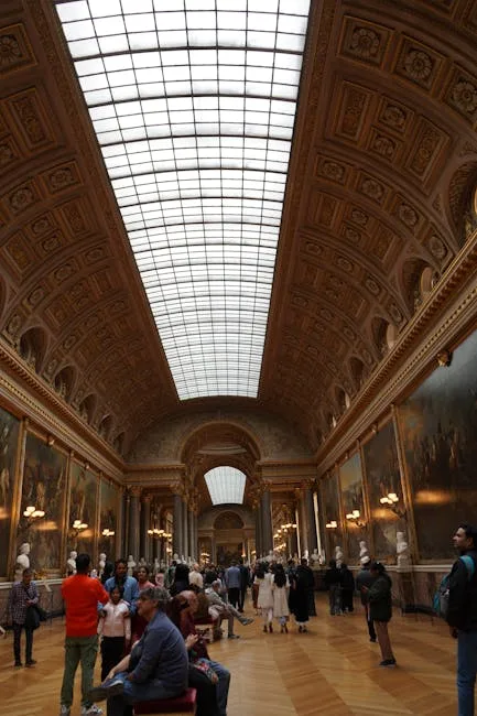 Grande salle de musée à verrière centrale, visiteurs assis et déambulant