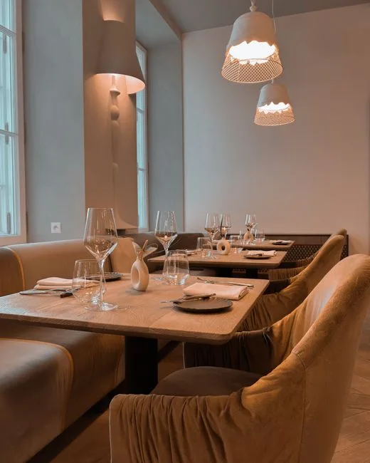 Intérieur moderne et feutré, tables dressées dans restaurant contemporain turinois