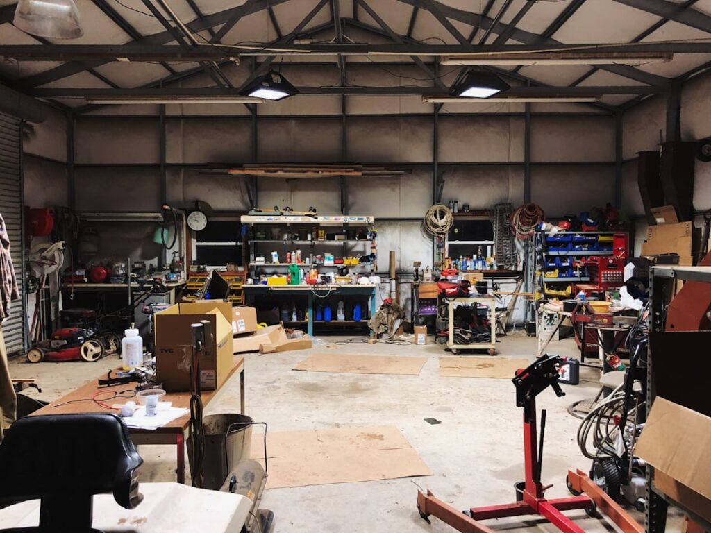 Spacious pottery workshop with tools, tables, and shelving on Amalfi Coast