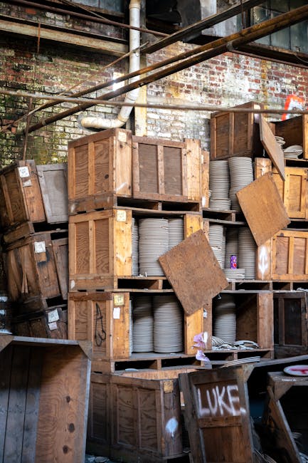 Wooden crates stacked holding ceramic plates in Amalfi Coast kiln storage