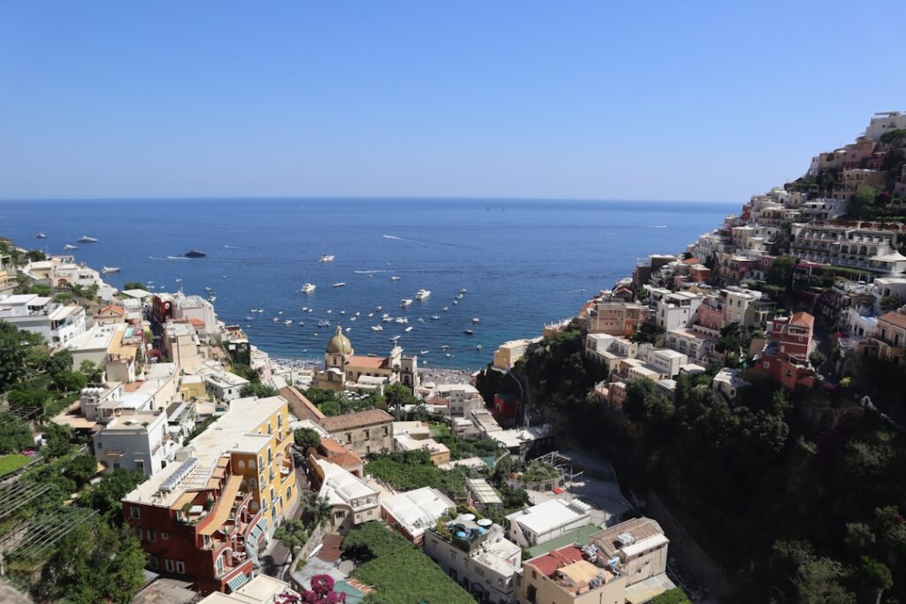 Coastal town rooftops and anchored boats on the Amalfi Coast bay