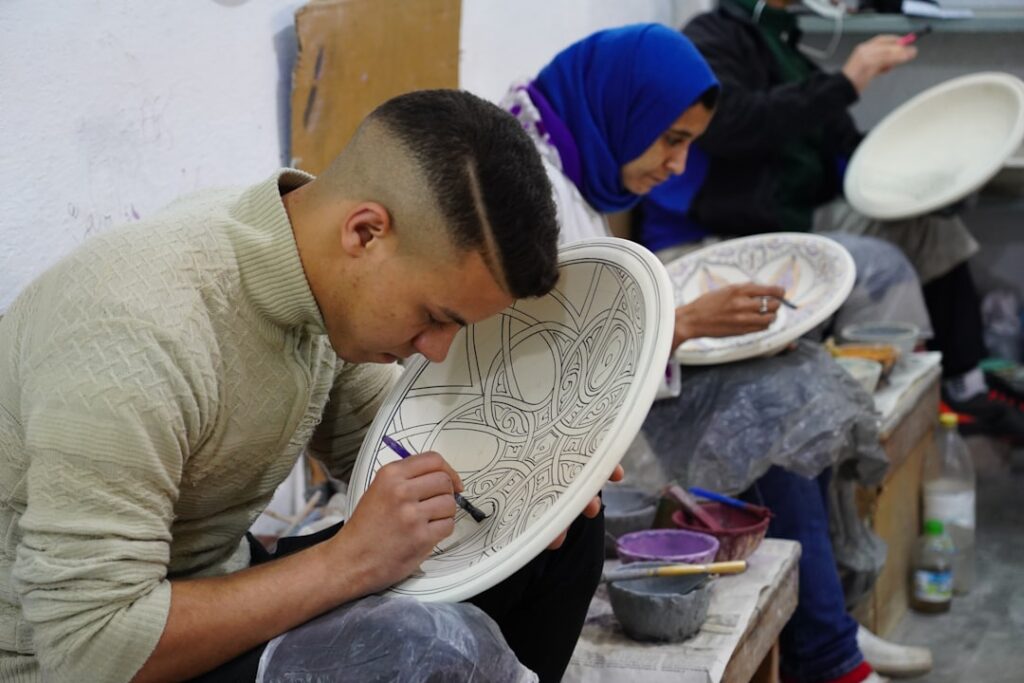 students painting plates in a pottery class