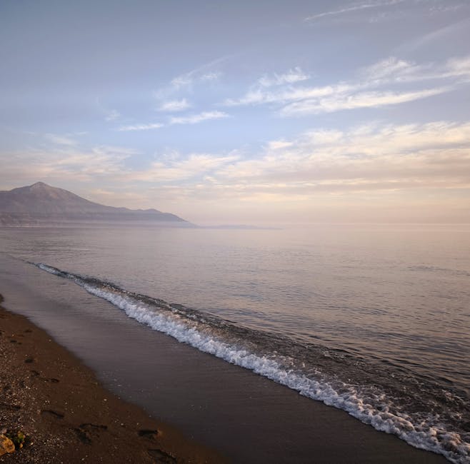 Gentle dawn wave lapping a quiet sandy shore on the Amalfi Coast