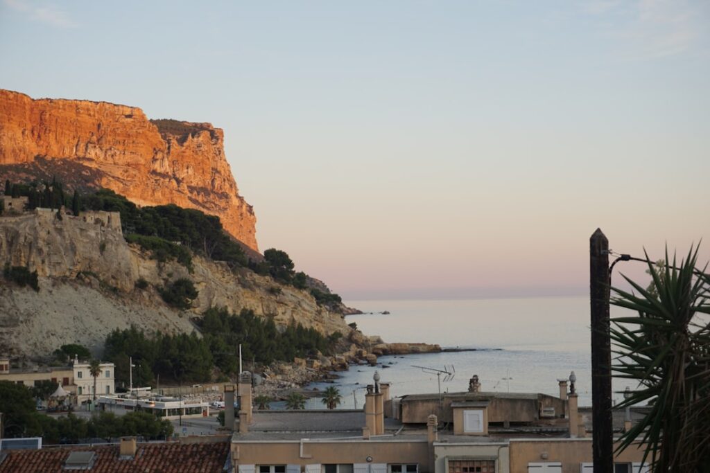 Coastal cliffs glowing at sunrise with rooftops on the Amalfi Coast