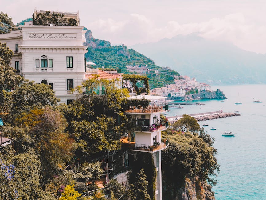 Hotel terraces clinging to cliffside above turquoise bay on the Amalfi Coast