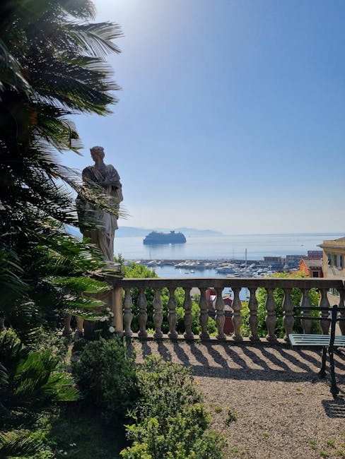 Marble statue beside balustrade overlooking harbor and cruise ship on Amalfi Coast