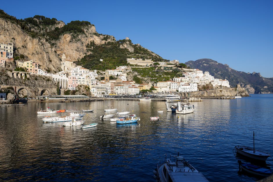 Barche ormeggiate davanti a Positano con villaggio sulla Costiera Amalfitana
