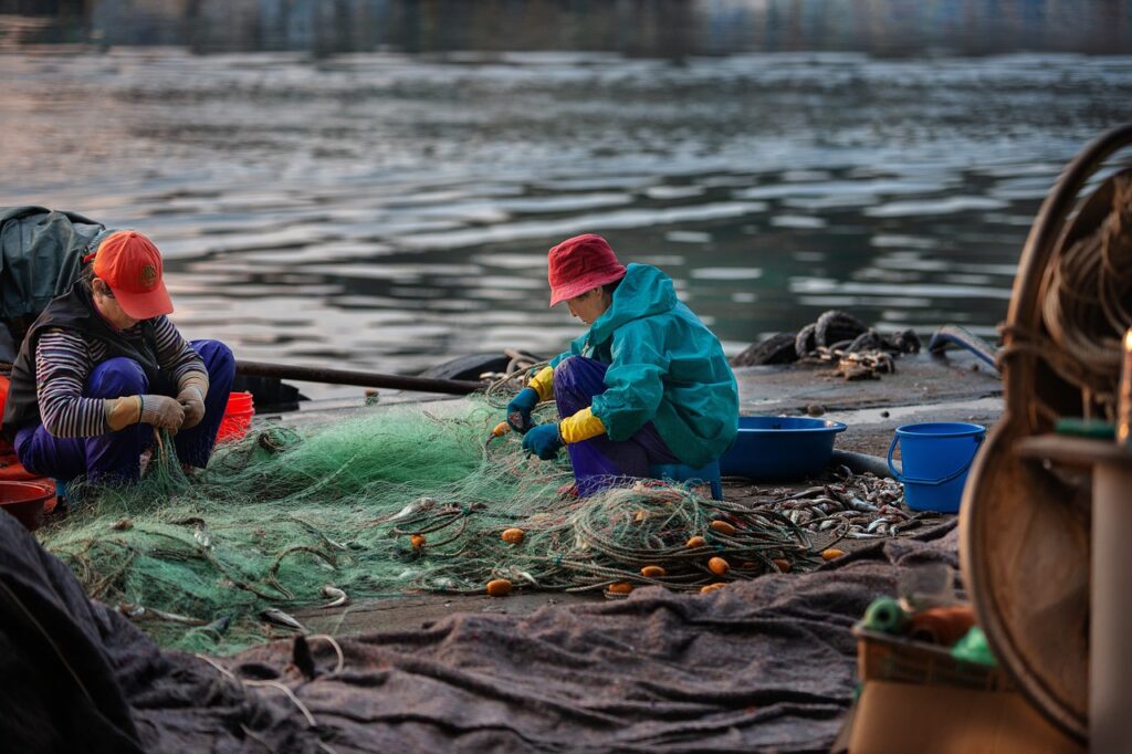 Pêcheurs réparant des filets au bord de l'eau sur la Côte amalfitaine