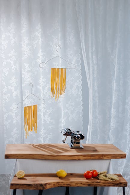 Fresh pasta drying on a wooden rack at home