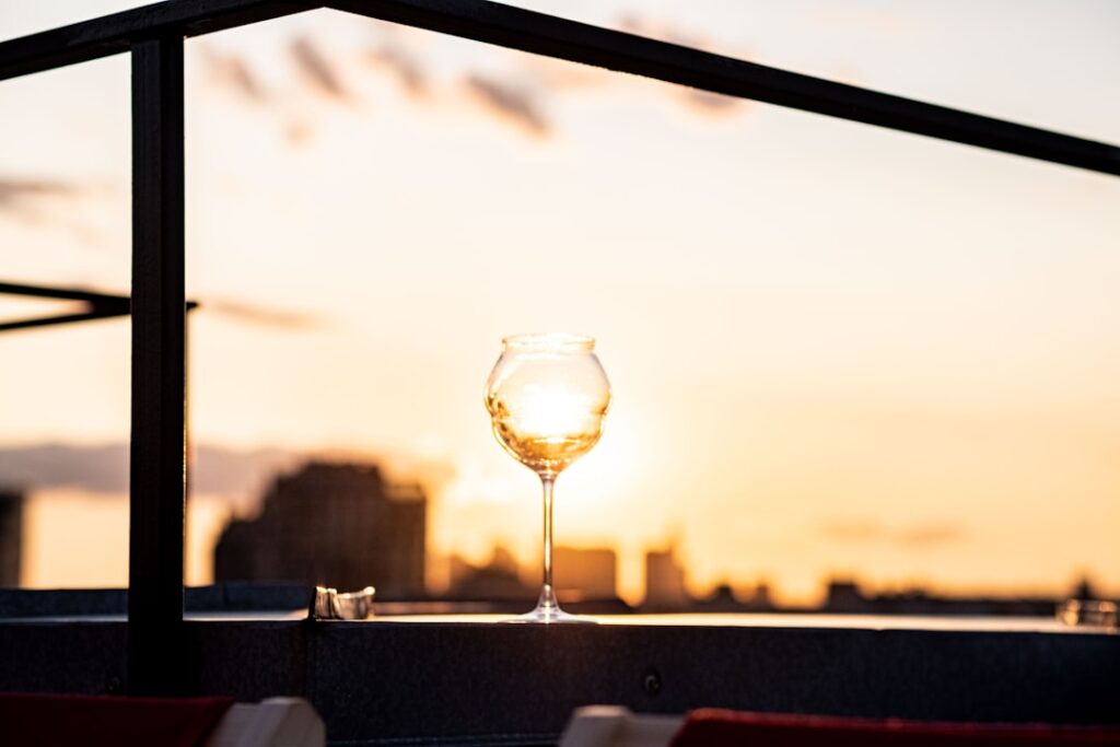 Cocktail on rooftop terrace at Grand Hotel et des Palmes at sunset