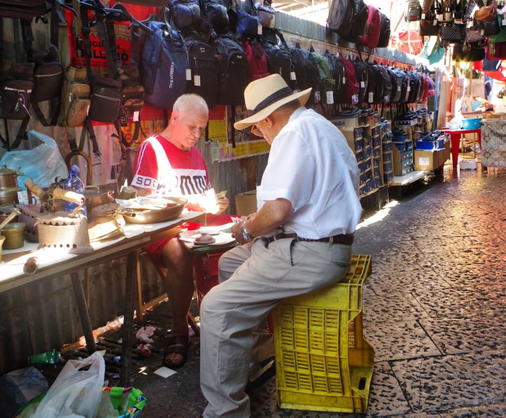 Locals chatting at a Palermo street market
