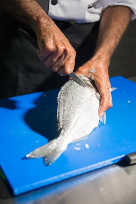 Chef file un poisson frais sur planche bleue, atelier à Palermo